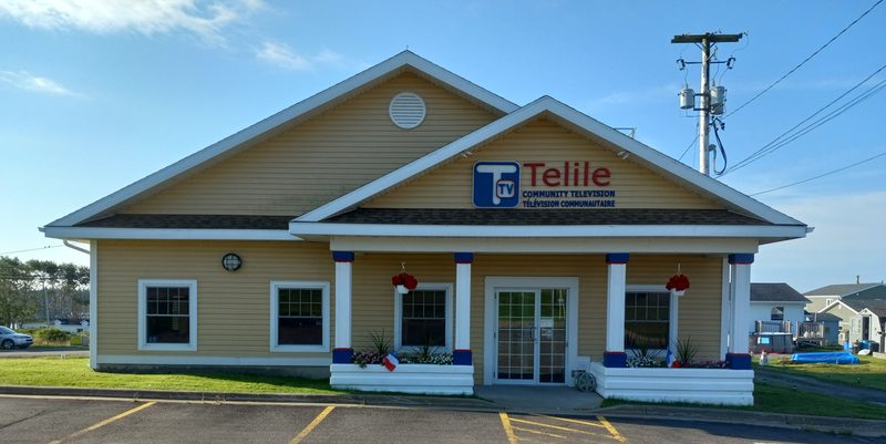 The Telile Community Television building on Conney's Lane in Arichat, yellow with white trim and the Telile sign over the porch