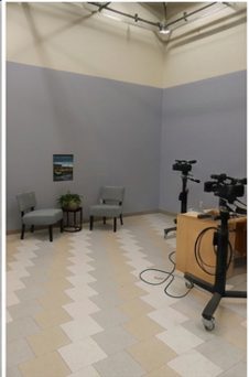Studio set with two chairs and a camera